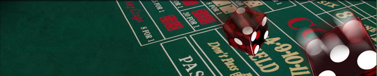 Craps table and two red dice rolling by.