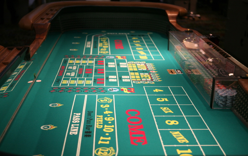 Long view of craps table at a casino.